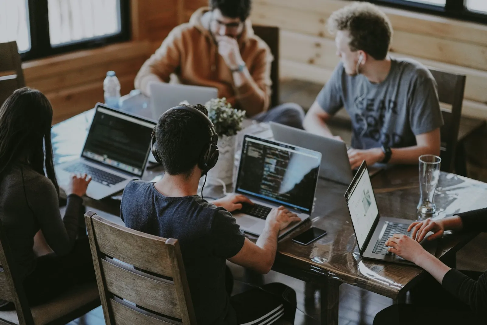 Security professionals collaborating around a laptop